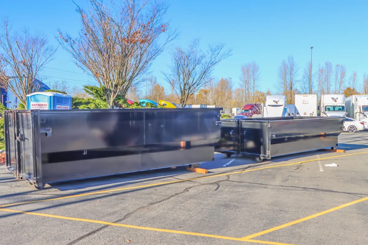 Professional dumpster rental service with roll-off container on residential driveway in Norman